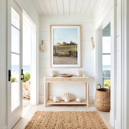 Create a bright coastal entryway with Summer Homes—a console table, large seashells, basket, rug, and ocean view.