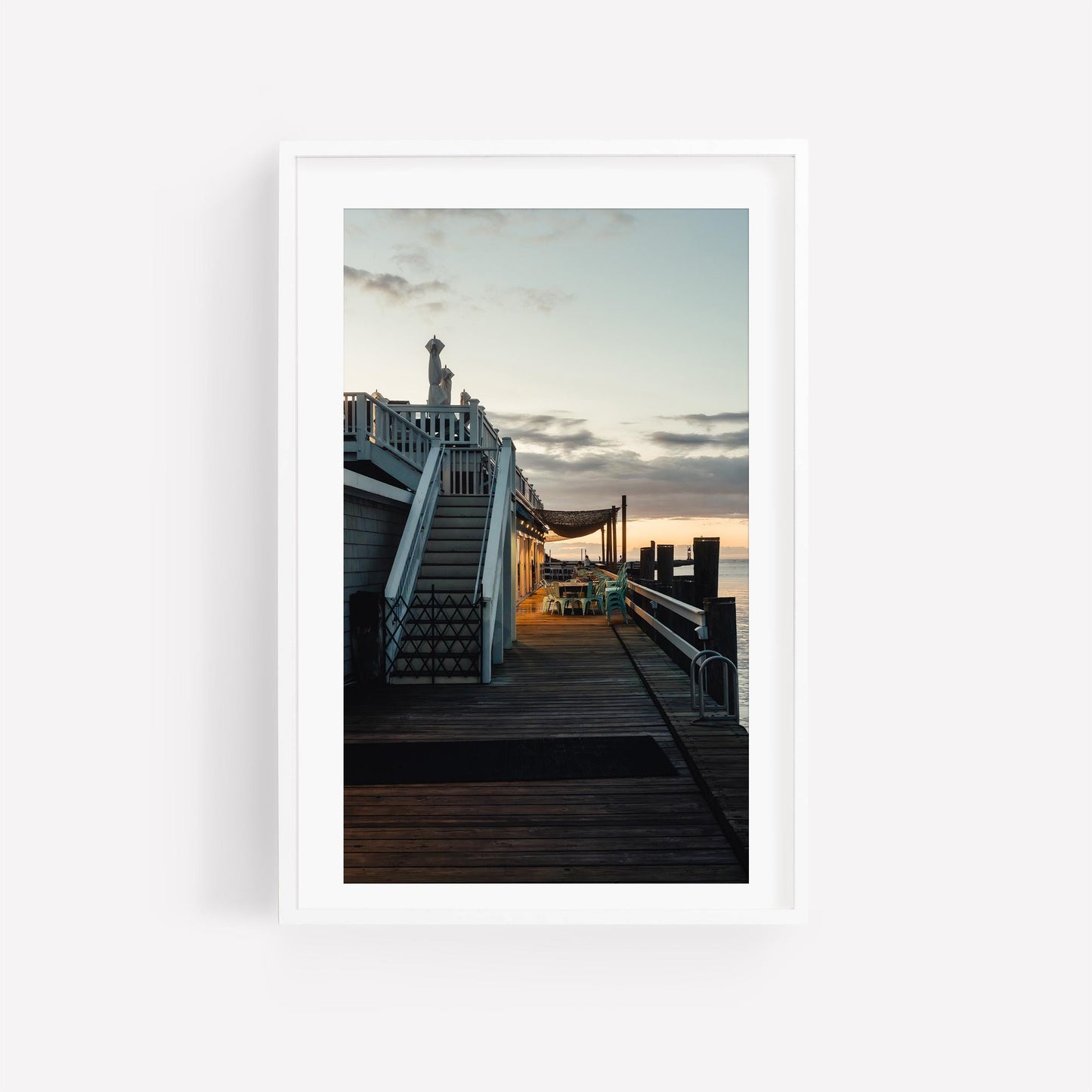 Dockside Evening: Framed photo of a boardwalk at sunset with stairs and seating by the water.