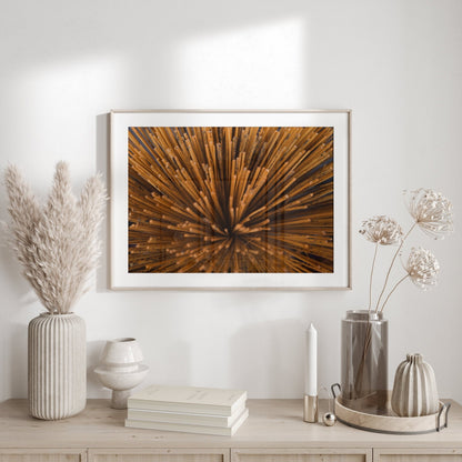 Framed Incense art on a wall above a wood table, adorned with vases and dried plants.