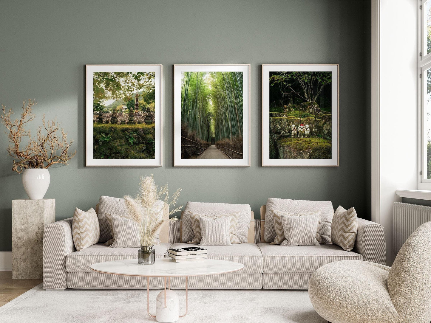 Modern living room with a beige sofa, cushions, a round coffee table, and Japanese Lush - Set of 3 on a green wall.