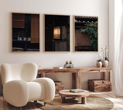 Cozy living room featuring a plush chair, wooden furniture, and the Japanese Serenity - Set of 3 framed wall art.