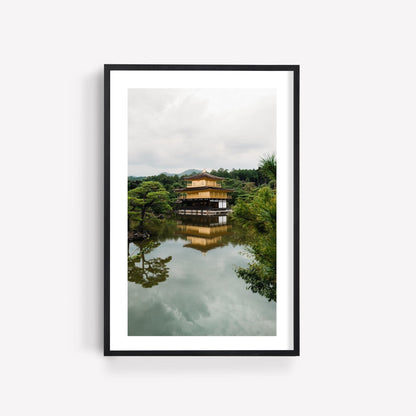 Framed photo of the Kinkaku-ji Temple, a serene lakeside building surrounded by trees with its reflection on the water.