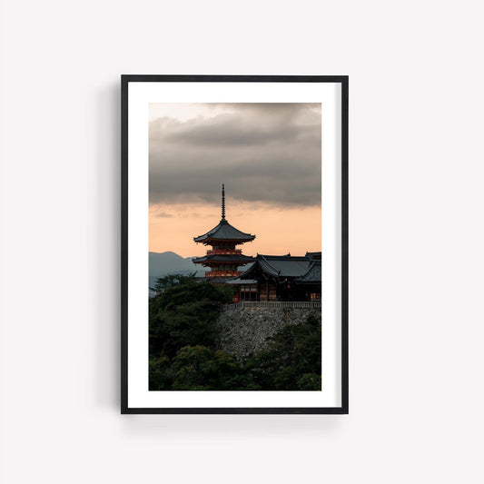 Framed photo titled Kiyomizu-dera Sunset I, capturing a traditional Japanese temple at sunset with a cloudy sky.