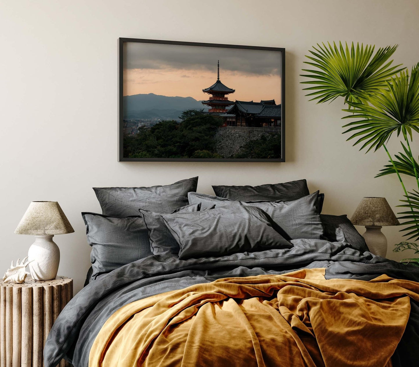 Cozy bedroom featuring Kiyomizu-dera Sunset II framed landscape, complemented by dark gray bedding and green plant accents.