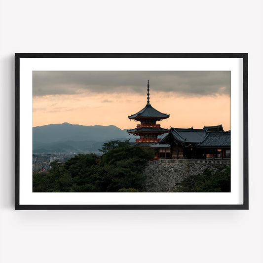 Kiyomizu-dera Sunset II: Framed photo of a traditional Japanese pagoda at sunset, with mountains in the background.