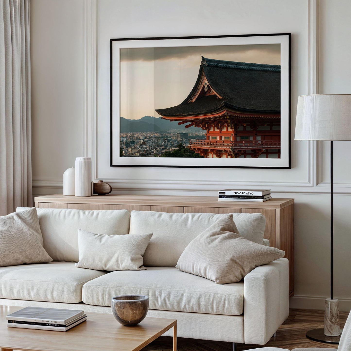 A framed Kiyomizu-dera Sunset III photo of a traditional building hangs in a modern living room with a white sofa and wooden furniture.