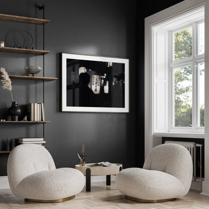 Two modern white chairs and a small table sit by the window beneath the Kyoto At Night Black and White wall art.