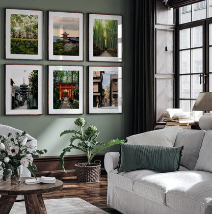 A stylish living room with white sofas, green accents, plants, and Kyoto - Set of 6 framed nature and city photos.