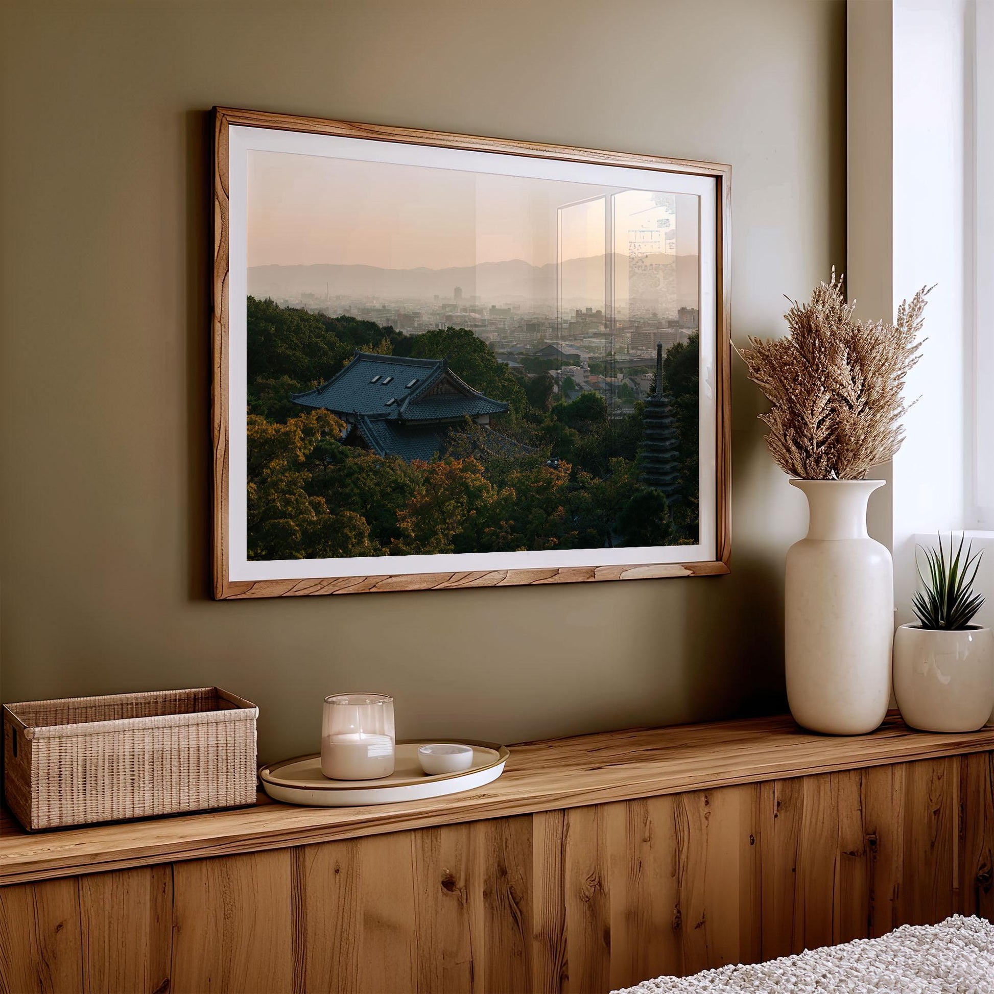 **Kyoto Sunset Skyline I** framed landscape photo displayed on a wooden shelf with decorative vases, a basket, and a candle.