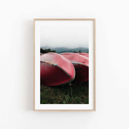 Framed photo titled Lake Kawaguchi Boats showcases red canoes on grass with fog-shrouded mountains in the backdrop.