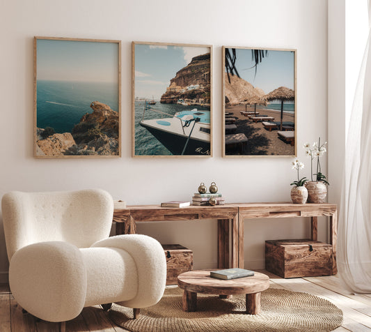 Cozy living room with a white chair, wooden furniture, and the Mediterranean Coast - Set of 3 on the wall.