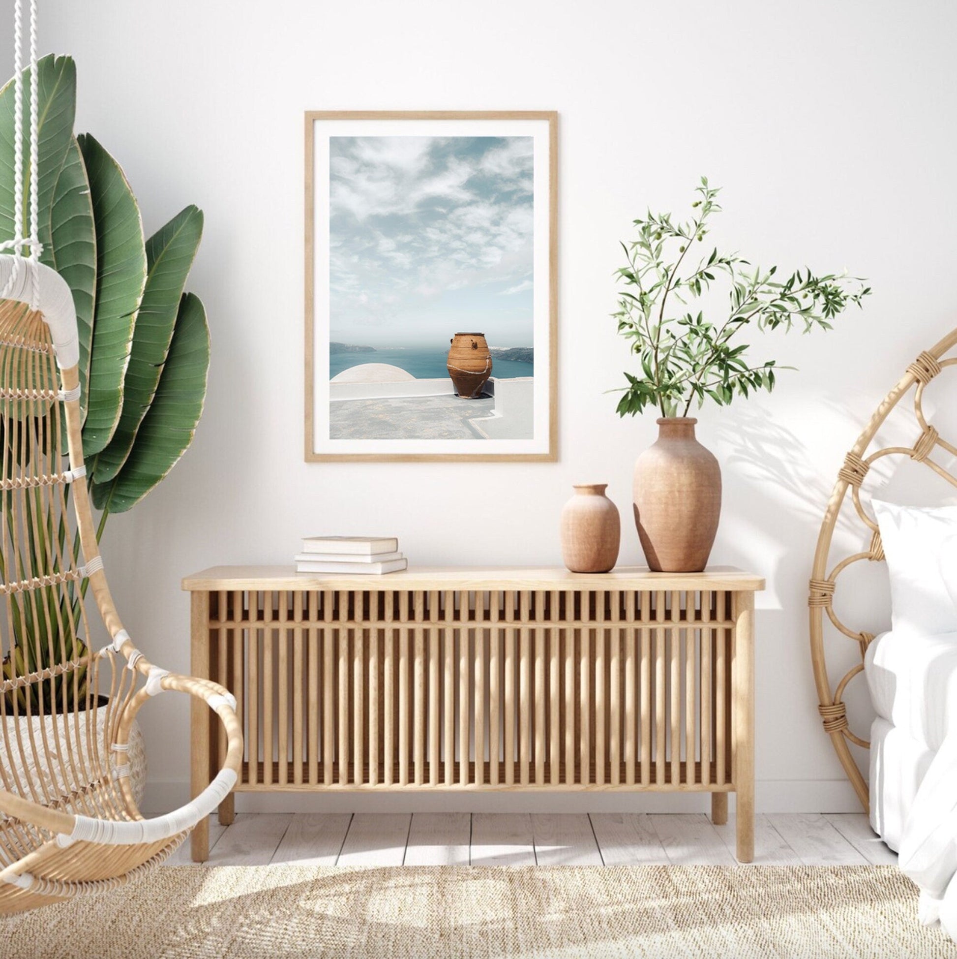 Minimalist room with wicker furniture, a Mediterranean Planter, and a framed sea view picture on the wall.