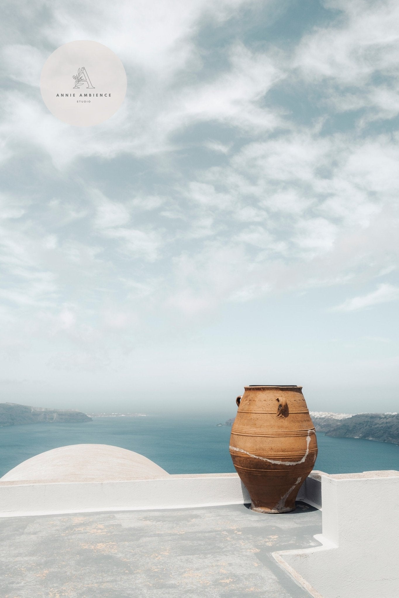 A Mediterranean Planter graces a white terrace, overlooking the blue sea and mountains under a partly cloudy sky.