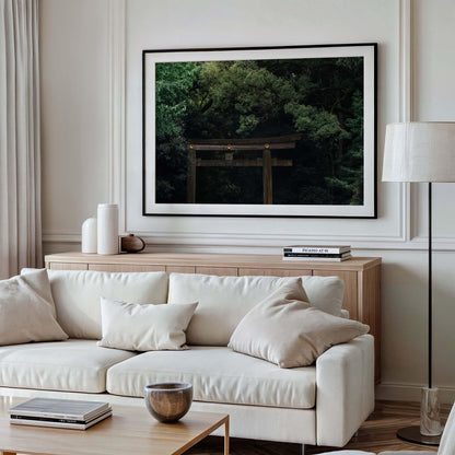 Minimalist living room with a white sofa, wooden table, and a framed photograph of Meiji Jingu Shrine on the wall.