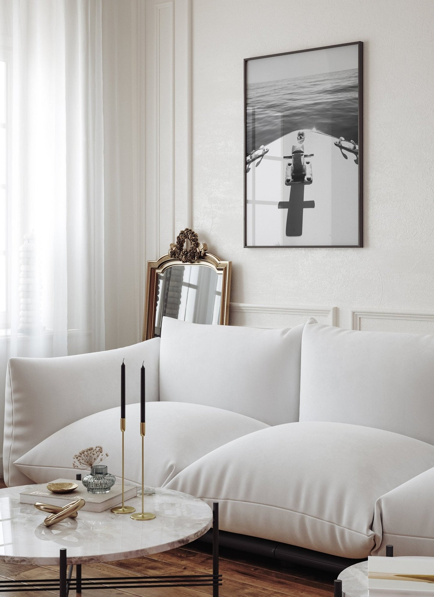 Modern living room with a white sofa, round marble coffee table with candles, and Midday Cruise Black and White art.