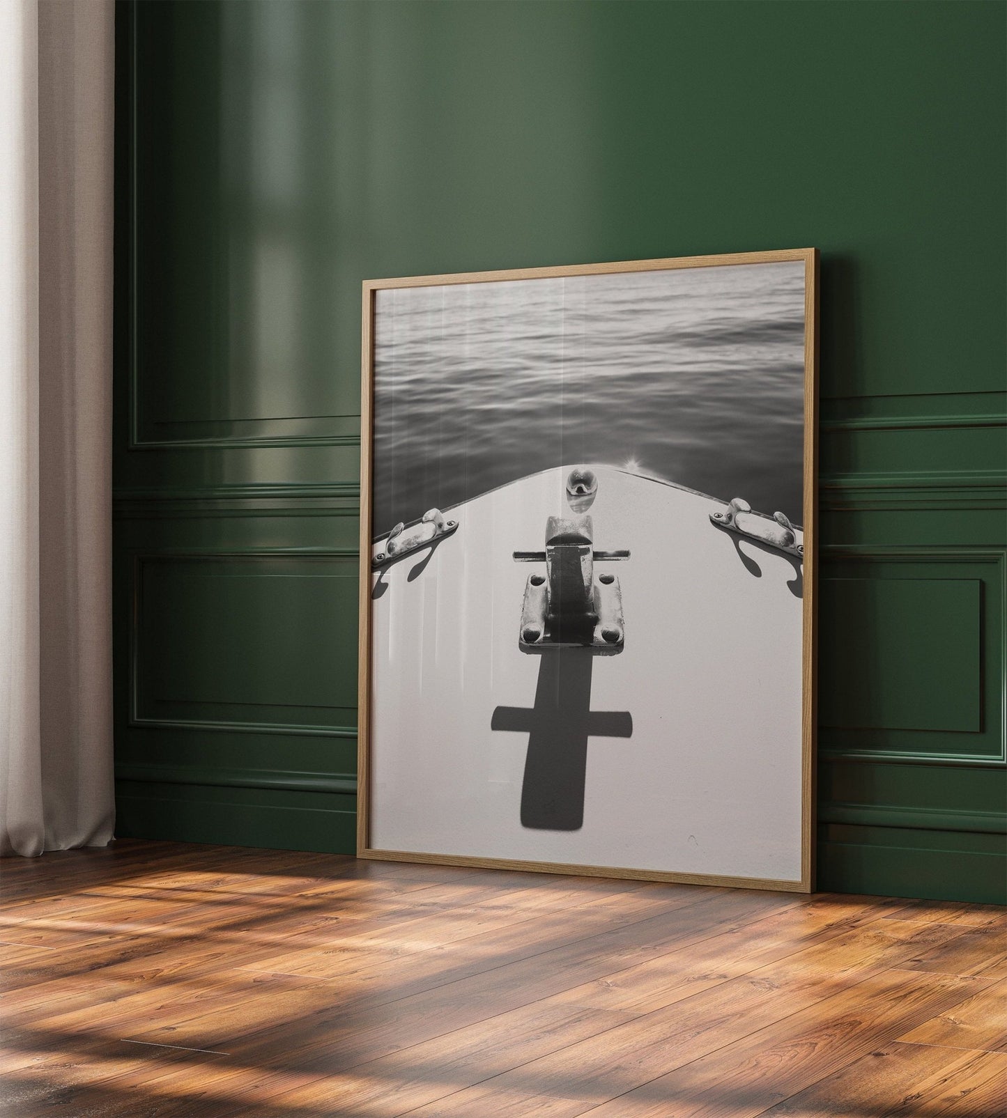 Midday Cruise Black and White photo of a boats bow leans against a green paneled wall on a wooden floor.