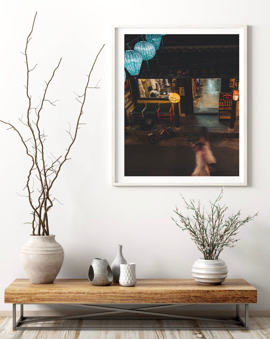 Midnight Memories framed photo above a wooden table with vases and branches.