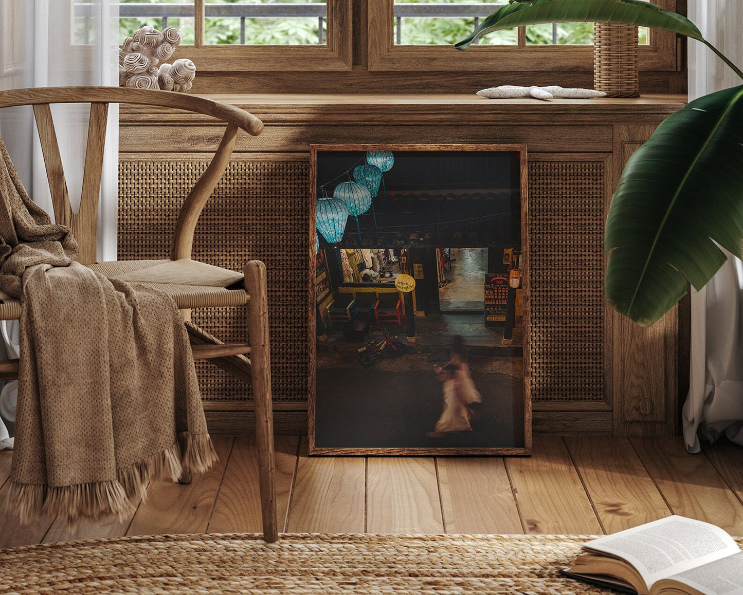 A cozy room with Midnight Memories chair, a green plant, and a painting leaning against a cabinet under a window.