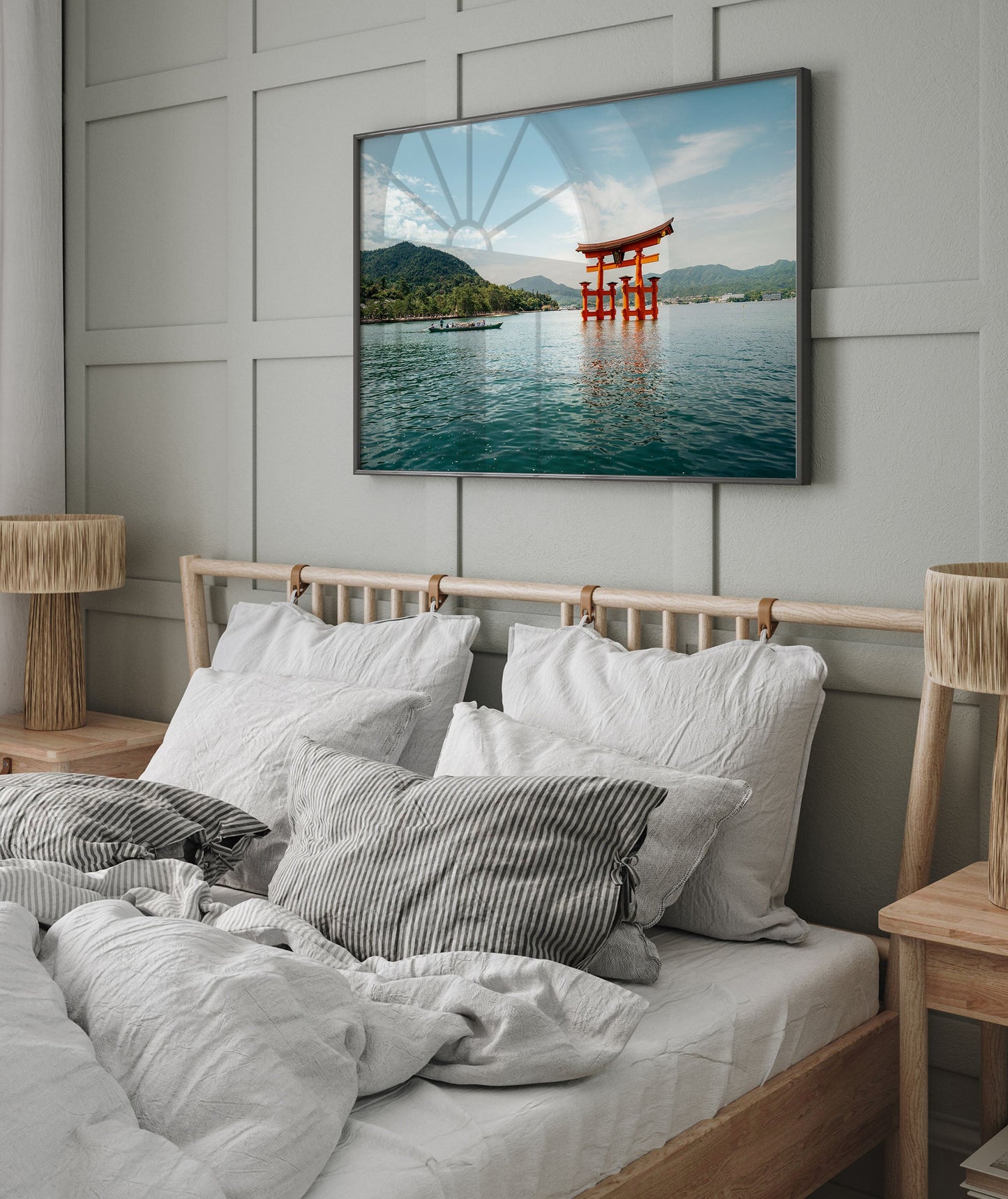 Cozy bedroom featuring a bed with cushions, Miyajima Passage I framed print, and wooden lamps.