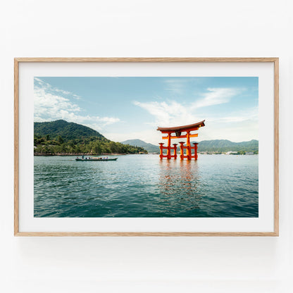 Framed photo Miyajima Passage I shows a red torii gate in water with a boat and mountains under a blue sky.