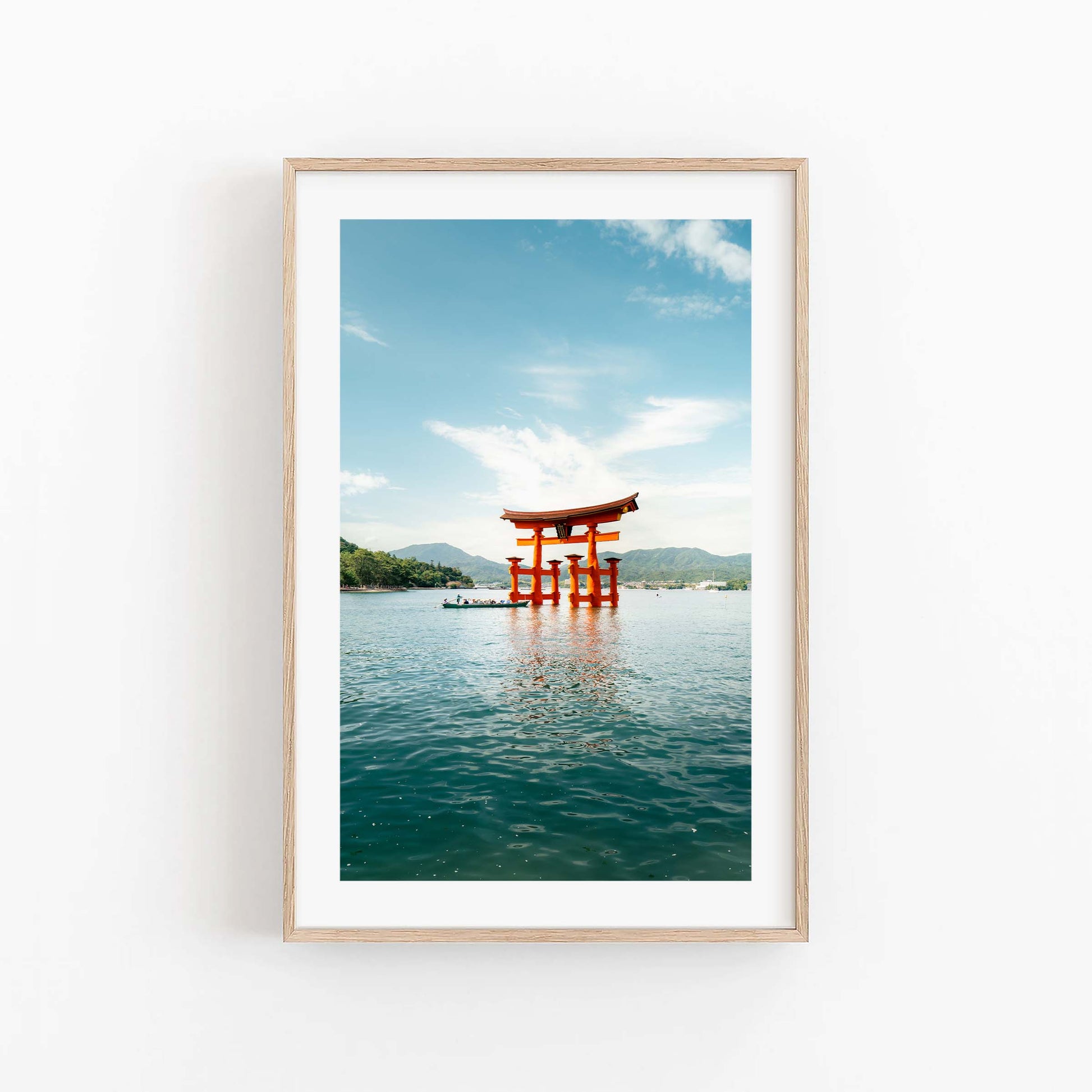 Framed photo: Miyajima Passage II - red torii gate in water, mountains, and a blue sky in the background.