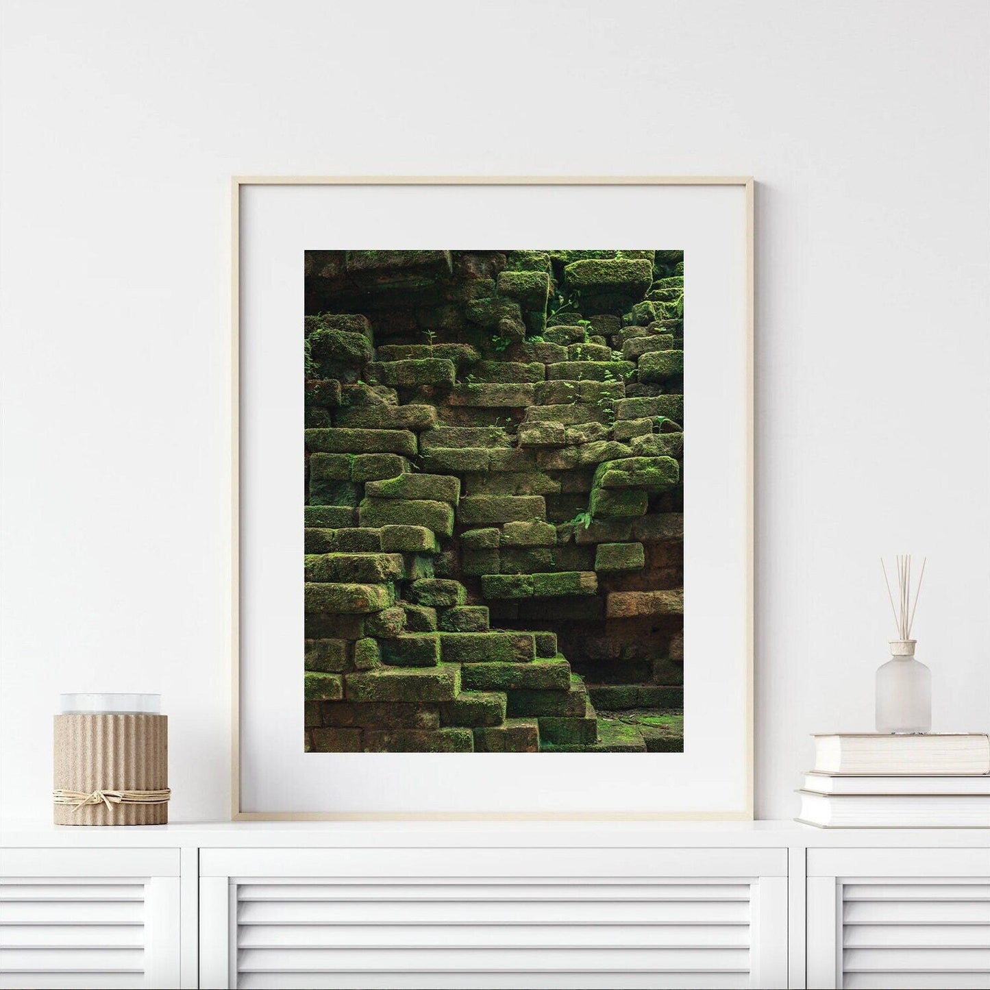 Mossy Elegance framed photo of ancient stone steps on a white shelf with decor.