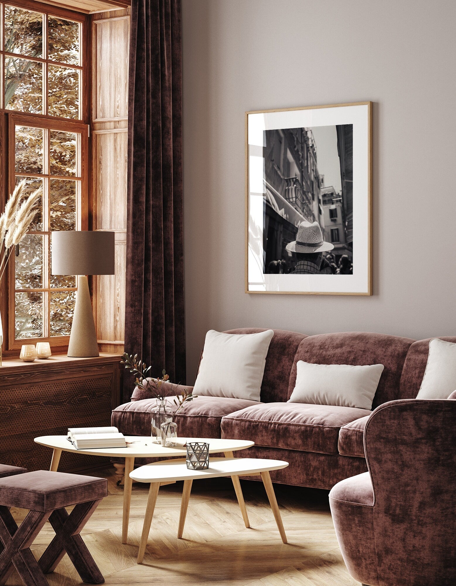 Cozy living room with velvet furniture, large window, and a framed Mystery Man Black and White photo on the wall.