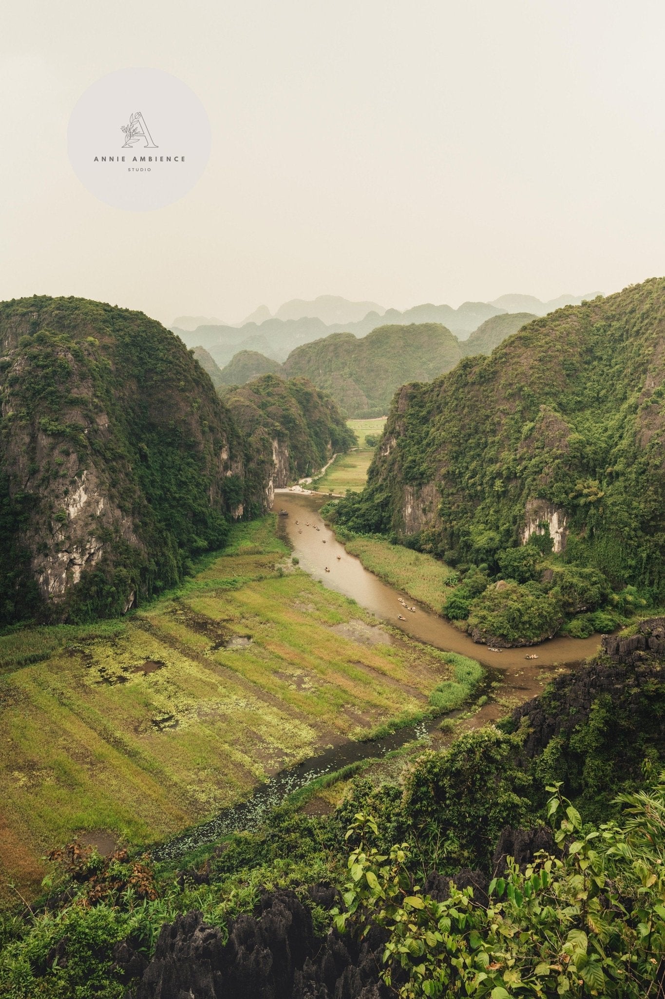 A lush valley with a winding river and steep hills under clouds. Ninh Binh - Set of 3.