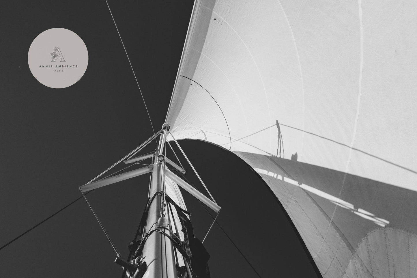 Black and white sailboat mast/sail image against the sky, Sailing Bliss logo in top left corner.