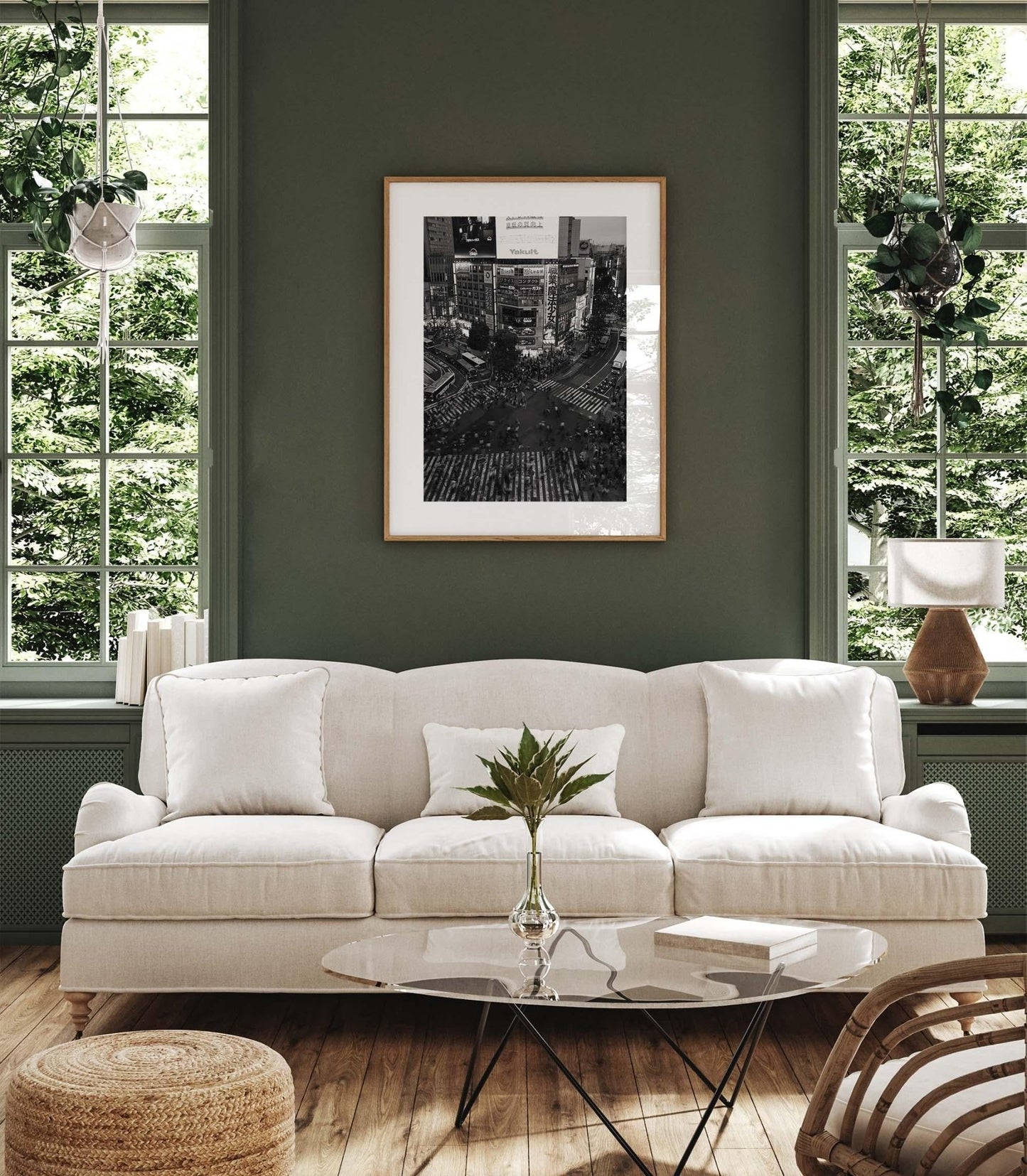 Elegant living room with a sofa, coffee table, and the Shibuya Crossing - Black and White wall art. Large windows offer a view of greenery outside.