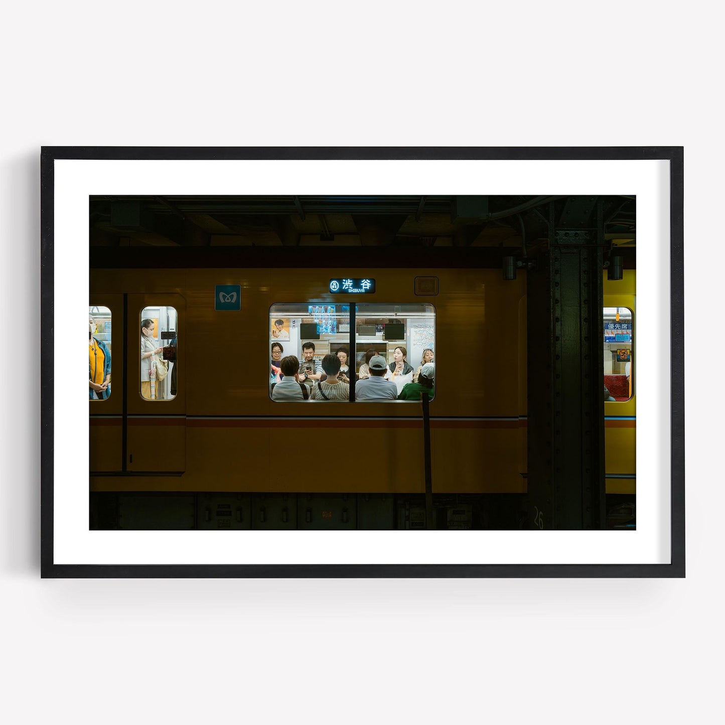 The Shibuya Station picture captures passengers on a dimly lit yellow train through the windows.