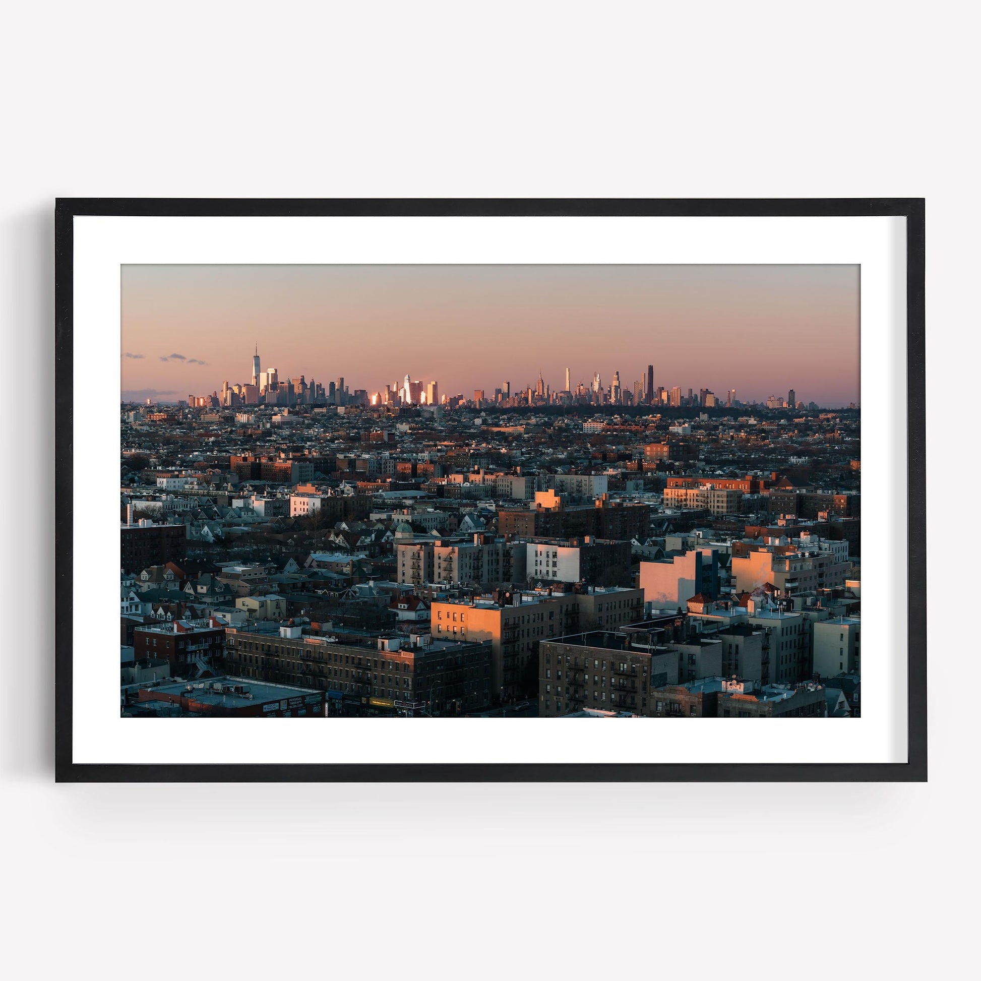 Framed photo titled Skyline From Brooklyn, featuring a sunset urban landscape with cityscape and foreground buildings.