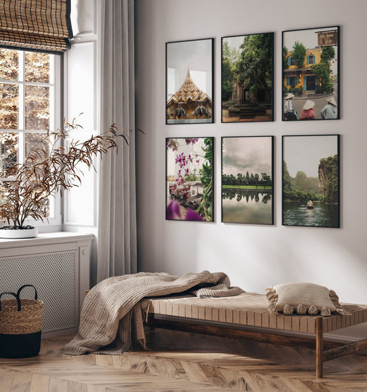 A cozy room features a woven bench, beige blanket, pillows, indoor plant, and six framed Southeast Asia nature photos.