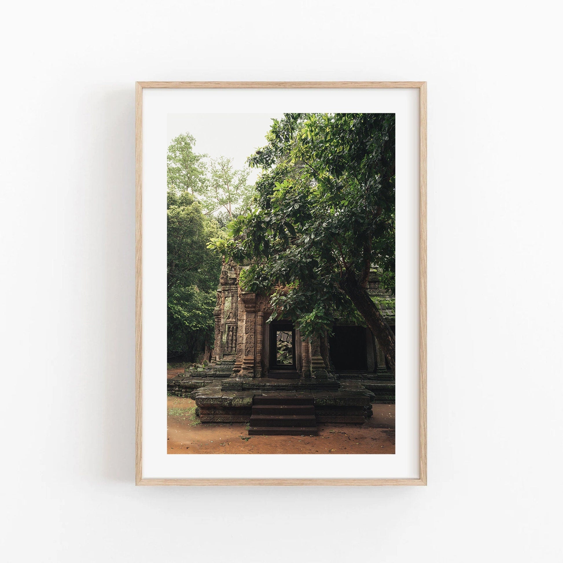 Temple II photo: ancient stone temple framed by lush trees, displayed on a white wall.