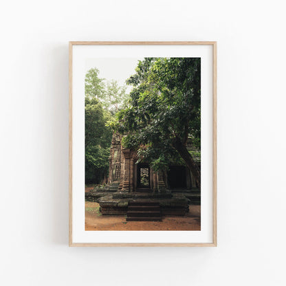 Temple II photo: ancient stone temple framed by lush trees, displayed on a white wall.