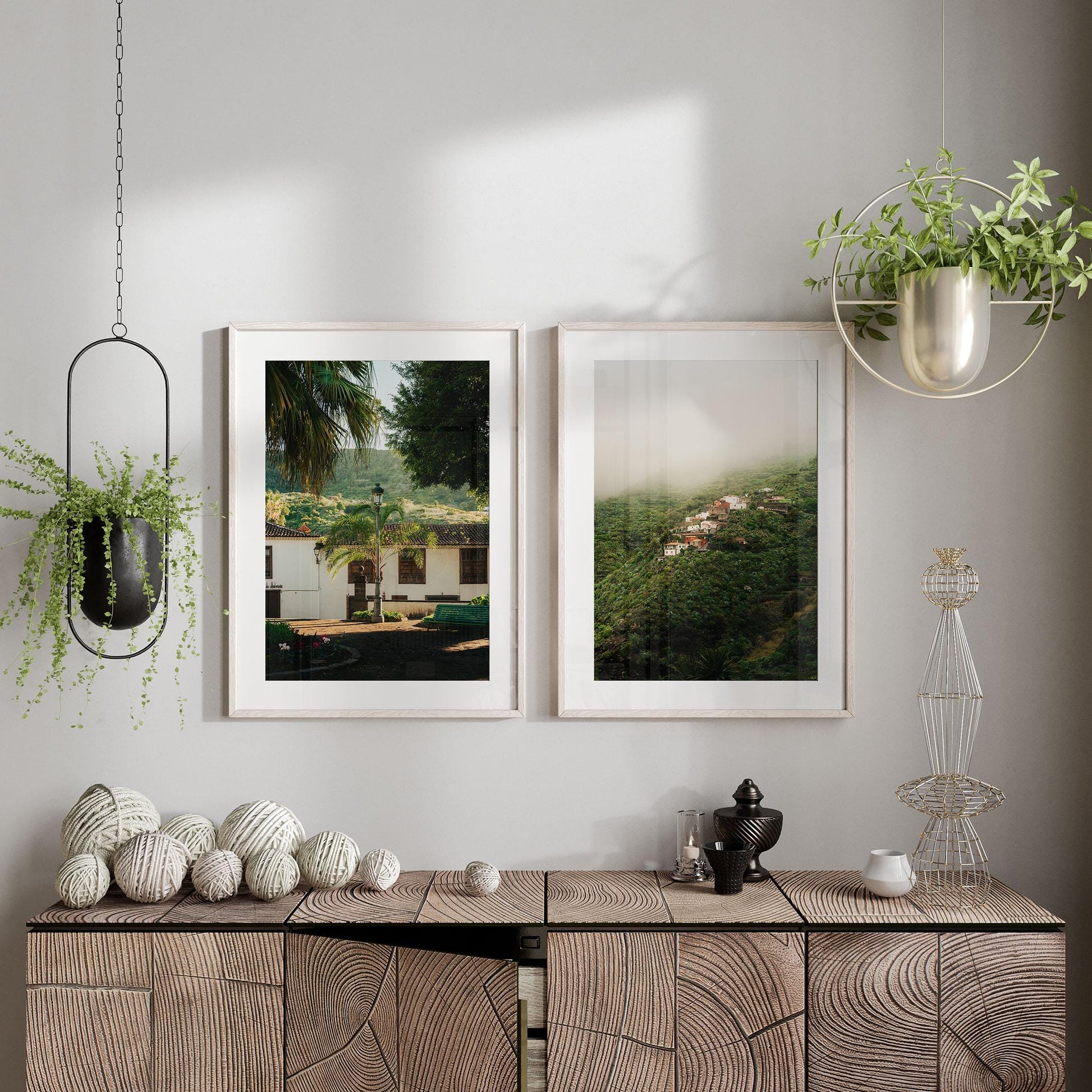 Modern interior featuring Tenerife Greenery - Set of 2, framed nature photos, and a textured wooden cabinet with decor.