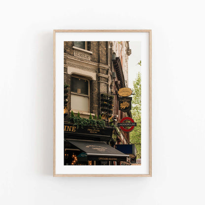 Framed photo of The Porcupine Pub with London Underground sign and historic buildings on a white wall.