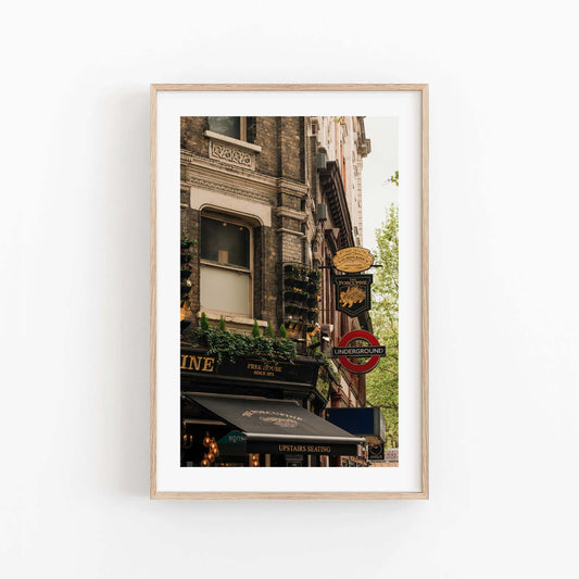 Framed photo of The Porcupine Pub with London Underground sign and historic buildings on a white wall.