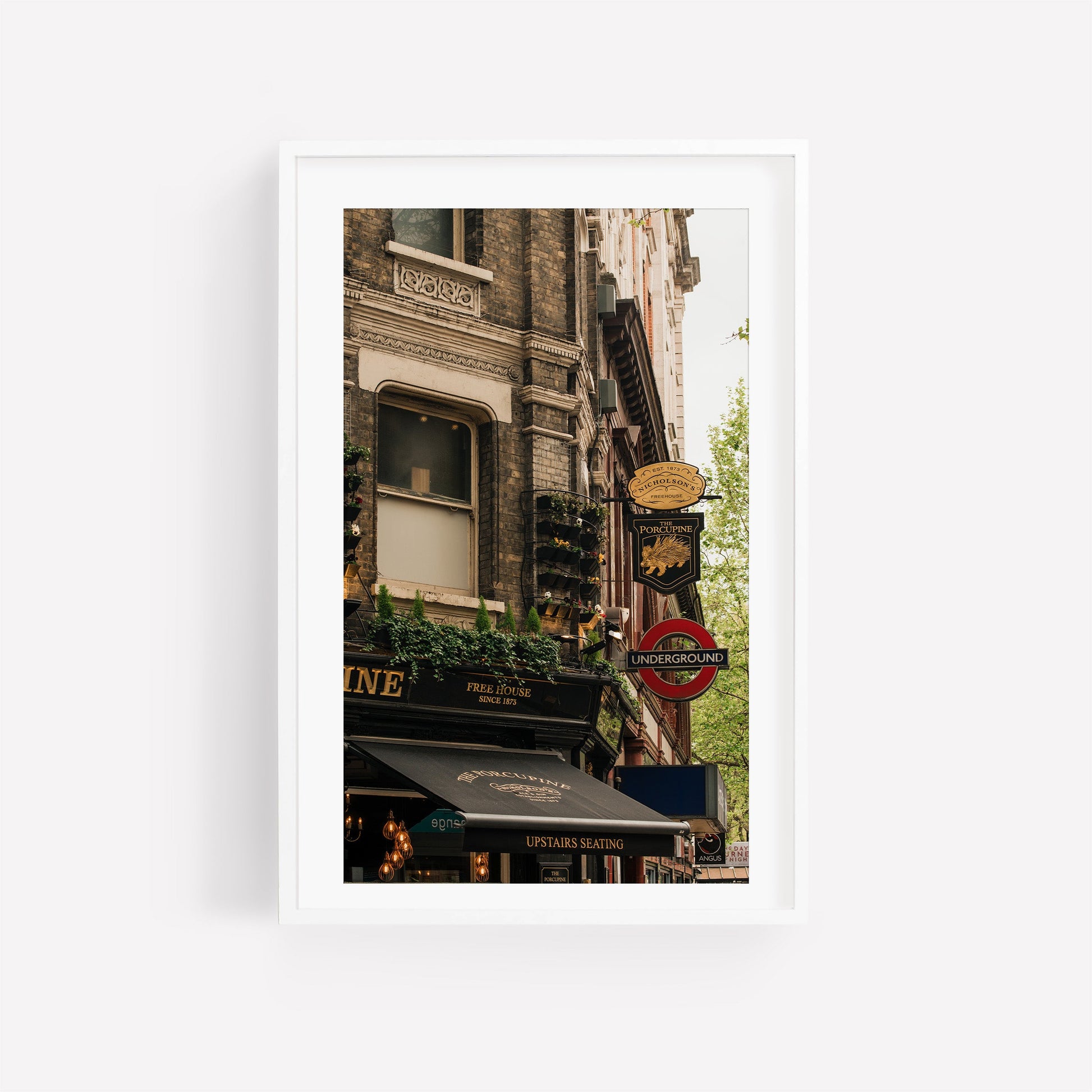Framed photo of The Porcupine Pub showing a London Underground sign and historic architecture.