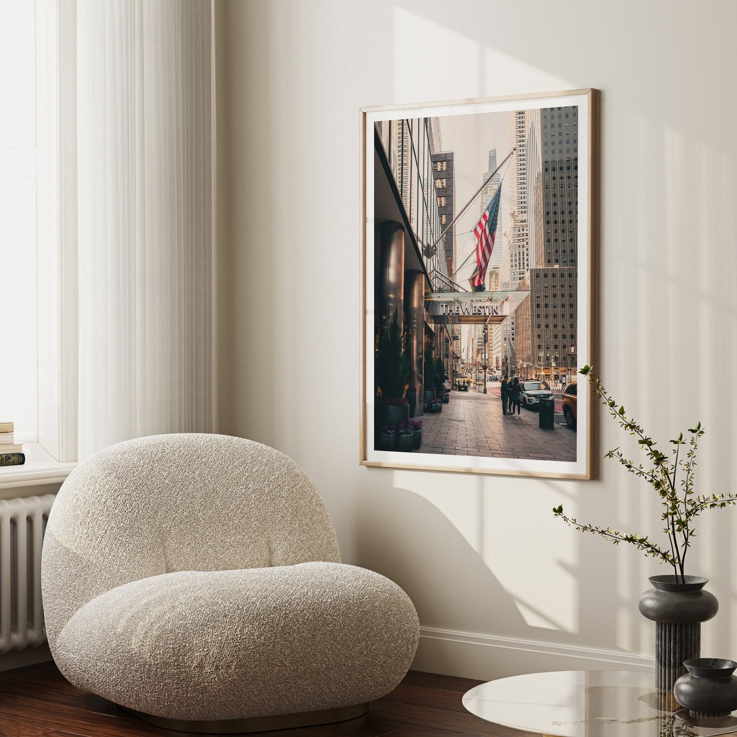 Cozy room with The Westin chair, a small table, and a cityscape photo on the wall.