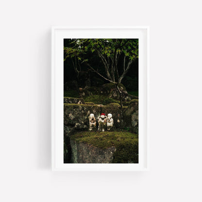 Framed photo titled Three Wise Ones features three small stone figures on mossy rocks in a lush forest.