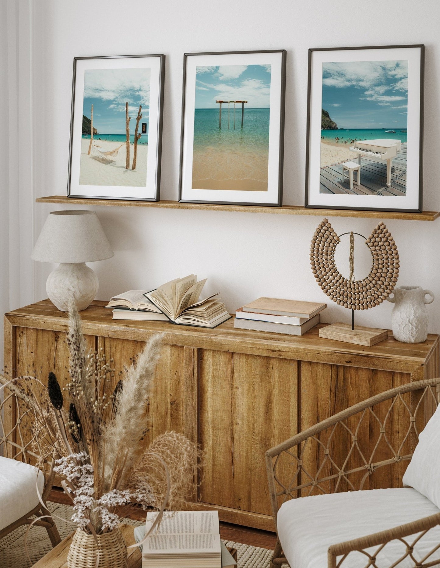 A cozy room with a wooden console, books, dried plants, and the Ky Co Beach photo set. Neutral tones create calmness.