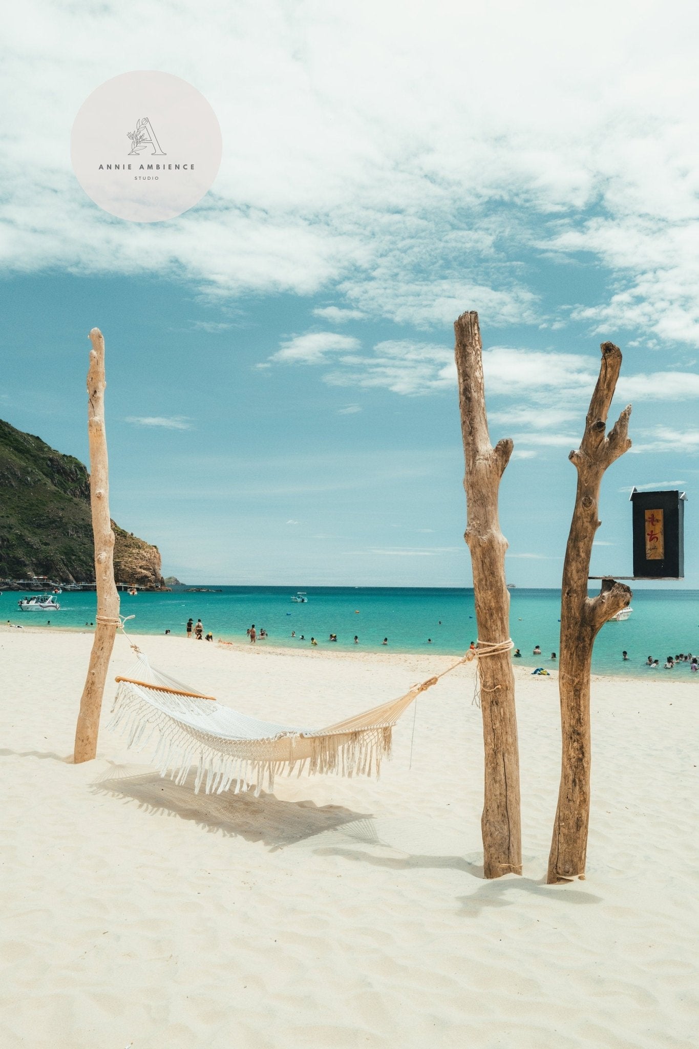 The Ky Co Beach - Set of 3 shows a hammock on a sandy beach, turquoise sea, and clear sky with people in the background.