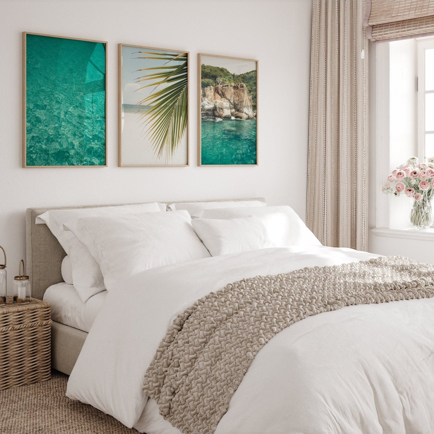 Bright bedroom with a white bed, beige knit throw, wicker nightstand, and Tropical Turquoise - Set of 3 pictures on the wall.