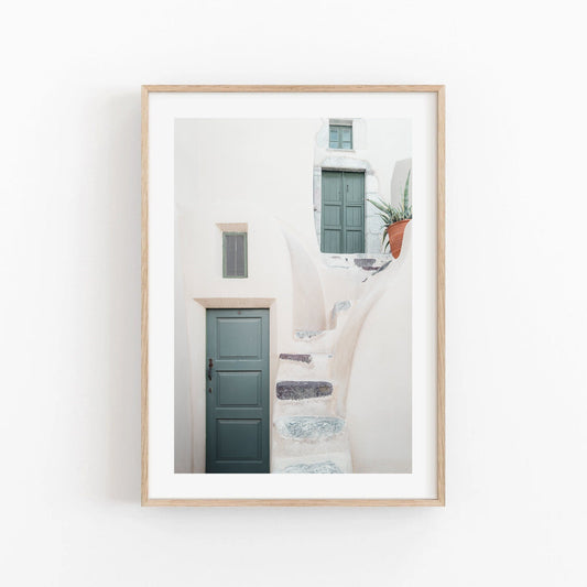 Framed photo titled Two Doors, showcasing curved white steps and a green door against a minimalist white wall.