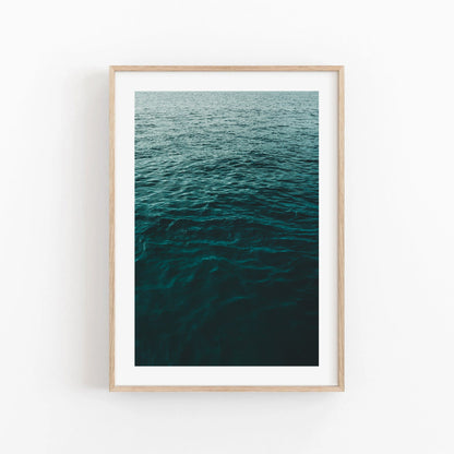 Water Ripples II framed photo displays deep ocean water waves on a plain white wall.