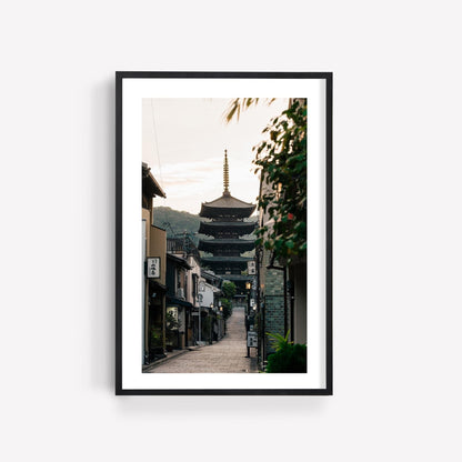 Framed photo titled Yasaka Pagoda At Sunrise, showcasing a serene street view with a pagoda temple in the distance.