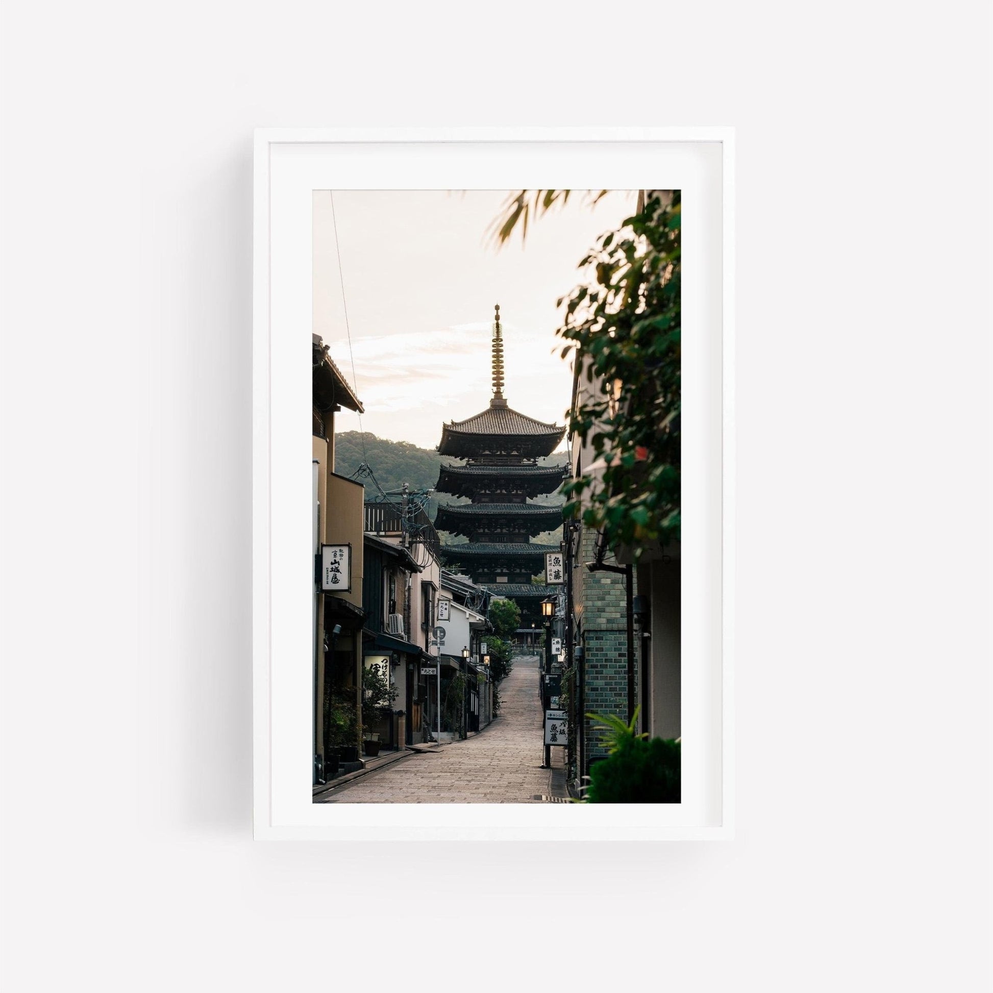 Framed photo titled Yasaka Pagoda At Sunrise depicting a traditional Japanese street with a pagoda in the background.