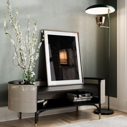 The Zen Ambience living room corner features a framed picture, floor lamp, and decorative vase elegantly placed on a woven bench.