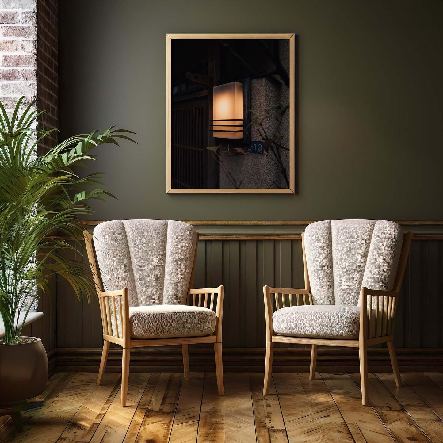 Two Zen Ambience beige armchairs rest on a wooden floor, framed by a picture-adorned green wall and accompanied by a nearby potted plant.